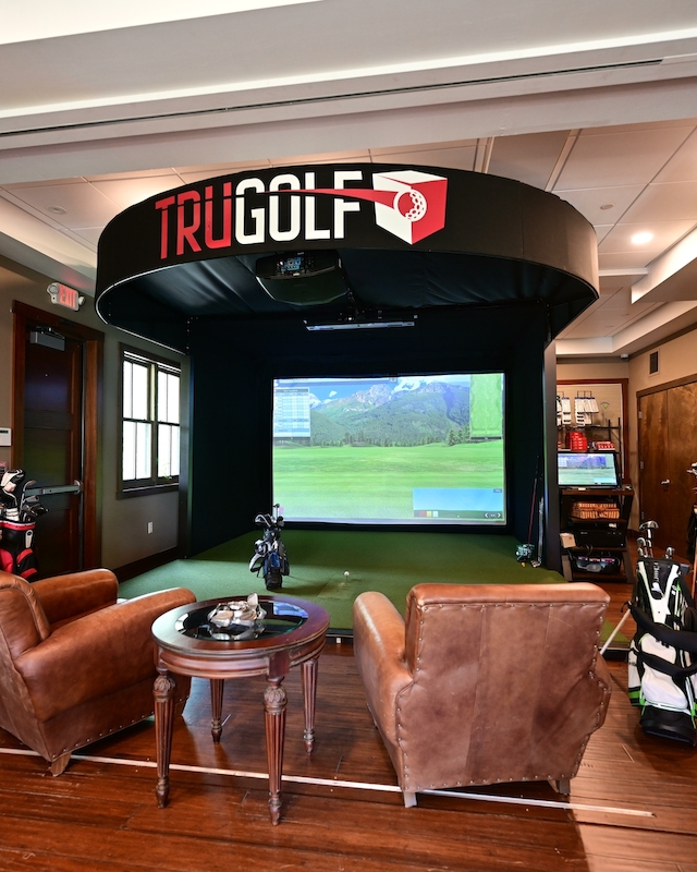 Luxurious golf simulator lounge at Preserve Resort & Spa, complete with TRUGOLF system.