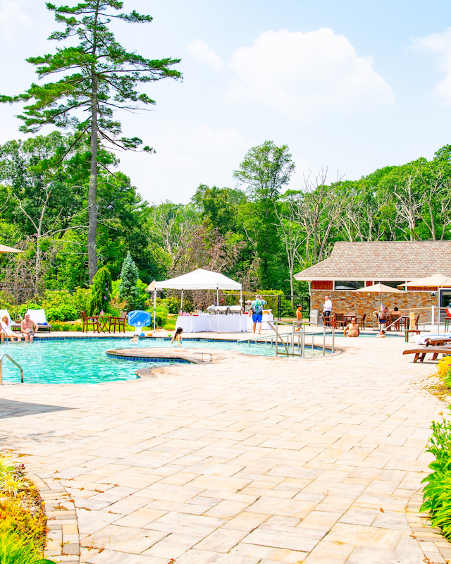 Summertime relaxation by the main pool at The Preserve Resort & Spa, a serene event space in Rhode Island.