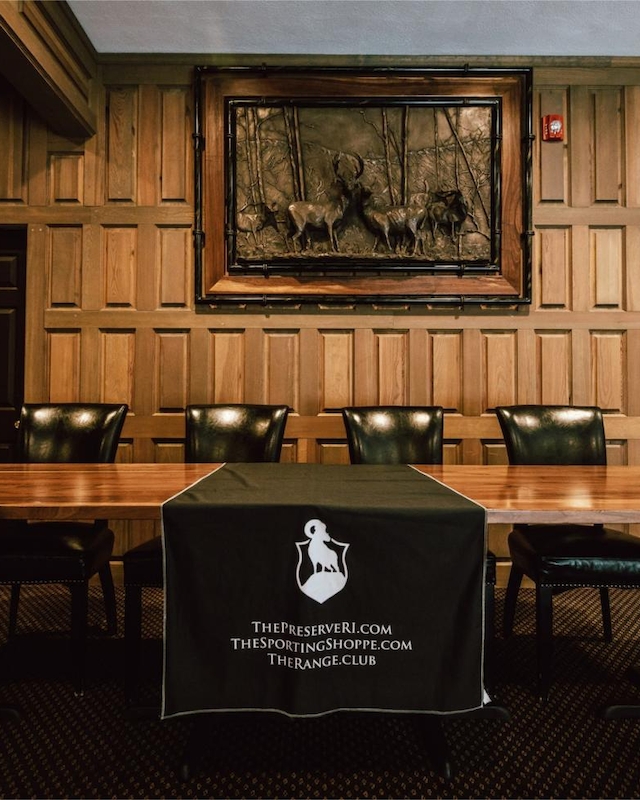 Traditional war room in the Club Room at Event Venue at The Preserve Resort & Spa in Rhode Island, featuring elegant wood paneling and a fireplace.