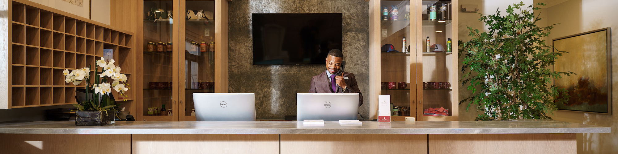 Sophisticated reception desk at Hilltop Lounge, Preserve Resort & Spa, with modern amenities for event guests.
