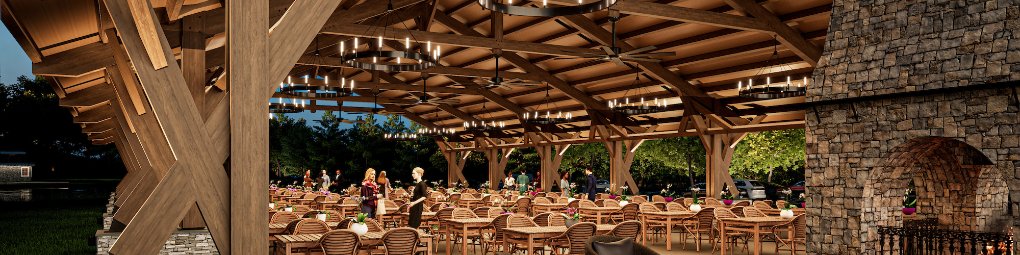 A cozy outdoor dining area with wooden beams, chandeliers, a stone fireplace, and numerous tables and chairs under a spacious roof.